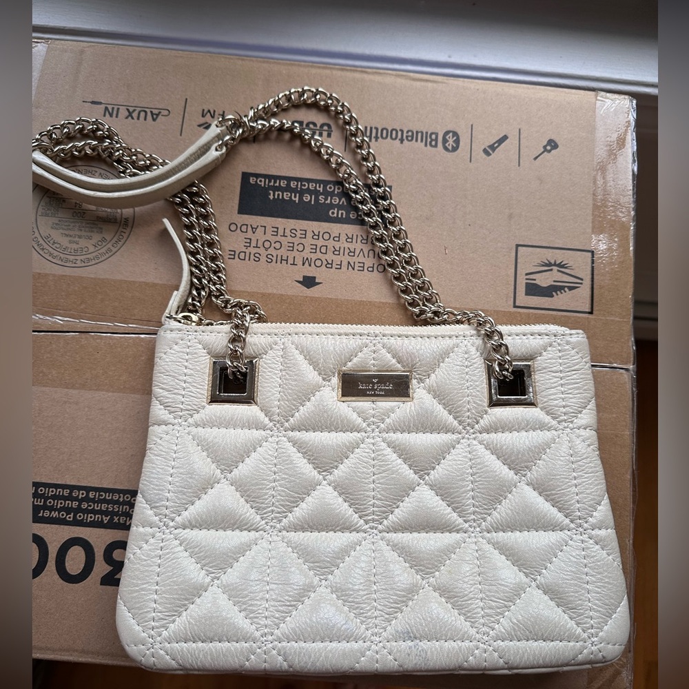 White Kate Spade mini bag with silver chain shoulder strap and quilted design